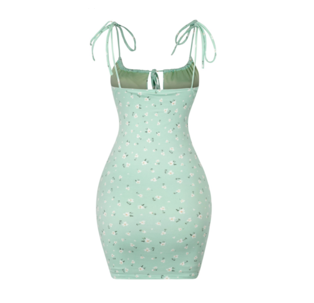 A sage green floral dress that's made for Spring. It features a drawstring and self ties. It's single-layered and is lined. Soft and stretchy Made in the US 96% Polyester / 4% Spandex