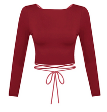 Load image into Gallery viewer, Show off some skin in this burgundy crop top! It features cross back detailing with a wrap tie.   Material: 96% POLYESTER 4% SPANDEX Made in the USA