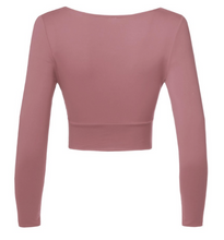 Load image into Gallery viewer, You&#39;ll look as beautiful as ever wearing this dusty rose colored long sleeve crop top. It features a v neck cut and side cut outs. The material is super stretchy, fitting, and soft.  96% Polyester 4% Spandex  Made in the US