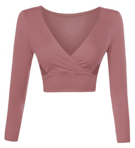 You'll look as beautiful as ever wearing this dusty rose colored long sleeve crop top. It features a v neck cut and side cut outs. The material is super stretchy, fitting, and soft.  96% Polyester 4% Spandex  Made in the US