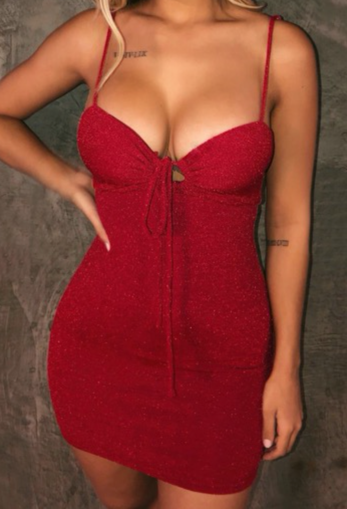 Are you ready to sparkle? This dress will have you shining bright with this captivating red dress. It ties in the front and is lined.   57% Nylon, 35% Silver Thread, 8% Spandex