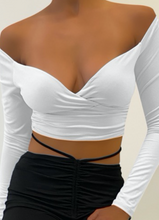 Load image into Gallery viewer, This stunning crop top is a need. It features a V neck and tunnel sleeve. Gold tip: pair it with our Flirty Flare Pants.  Made in the US 96% Polyester 4% Spandex