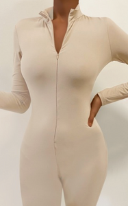 A must-have! It features a mock neck, zipper, and figure-hugging brushed material. It can be layered or worn alone for a comfy fit. It'll keep you warm, but the material is breathable. It is also super soft!  Made in the US 82% Polyester / 18% Spandex