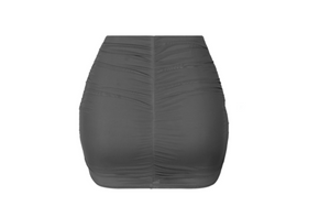 This mini skirt has a mesh overlay. It features: Lined Stretchy  Mesh overlay Made in the US Ruched detailing