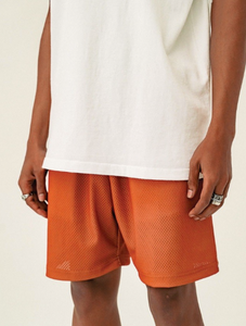 Football mesh shorts that include two pockets in the front, an elastic waistband, and a drawstring at the waist.  100% Polyester Made in Los Angeles  The model is wearing a medium:  Waist size 33 Inseam - 6" Front rise - 11" Leg opening - 12.75"