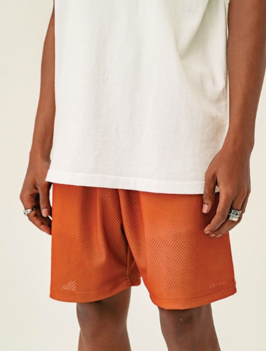 Football mesh shorts that include two pockets in the front, an elastic waistband, and a drawstring at the waist.  100% Polyester Made in Los Angeles  The model is wearing a medium:  Waist size 33 Inseam - 6